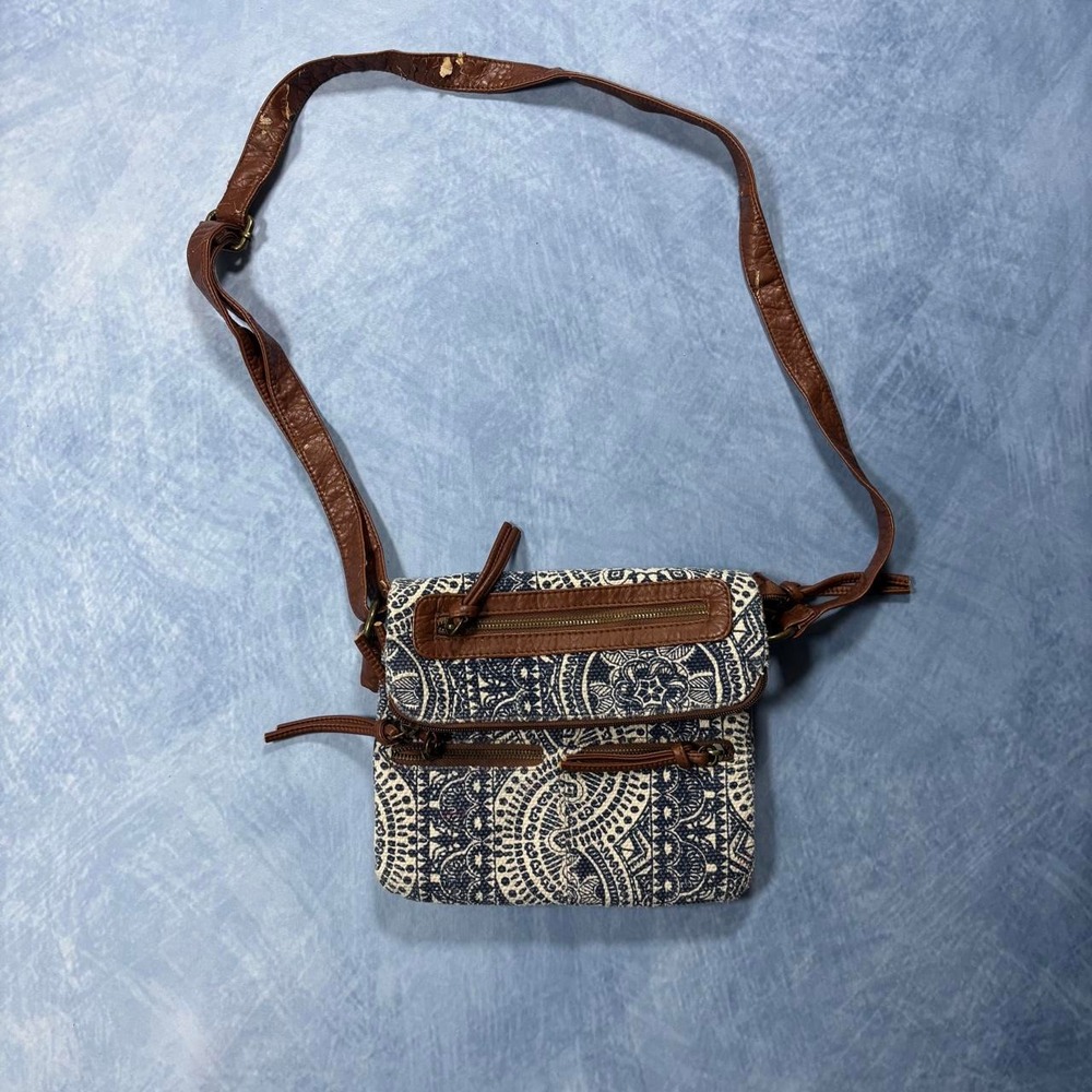 blue and white crossbody bag with brown leather straps